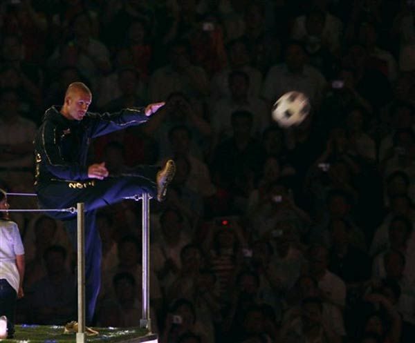 Also in the bus: David Beckham, who kicked a soccer ball into the crowd.